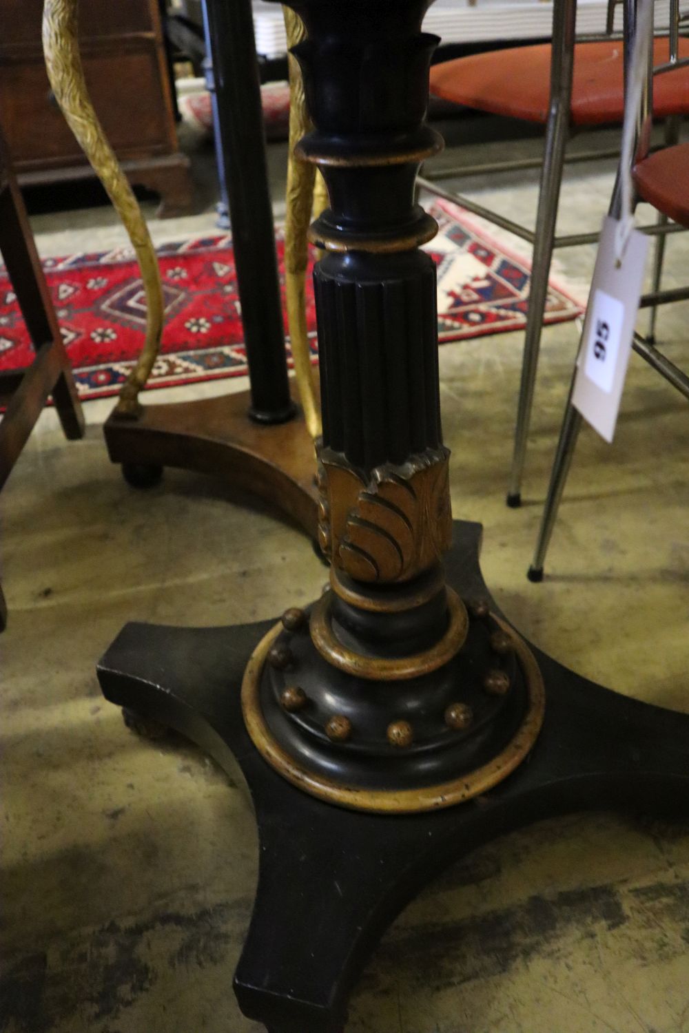 An early Victorian gilt ebonised circular slate top table, 55cm diameter, height 70cm